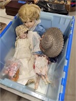 Bin of Various Dolls & Doll Clothes Largest Doll