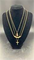 Three gold colored necklaces, bear, cross