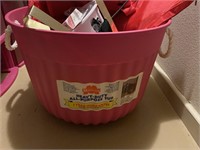 Pink bucket with rope handles with contents