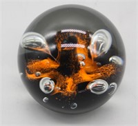 S: APPROX 3" DIA. BLACK & ORANGE PAPERWEIGHT