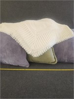 White afghan and coach pillows