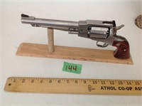 Black powder pistol on wood stand
