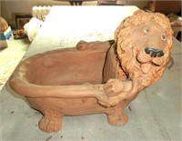 terra cotta lion in bathtub