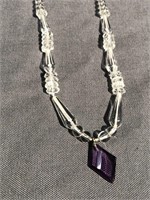 Crystal necklace with cut amethyst at the bottom