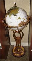 Unique world globe on ornate stand. Measures 37"