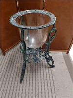 Wrought iron base plant stand with glass insert.
