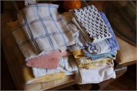 Lot of hand towels and wooden veggies