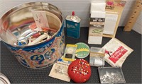 Tin can of sewing items