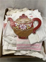 Box of vintage linens and a wooden teapot cup