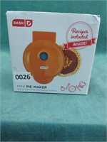 Dash 4" mini pie maker in orange. It comes