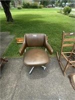 Vintage brown vinyl office chair and wooden shelf