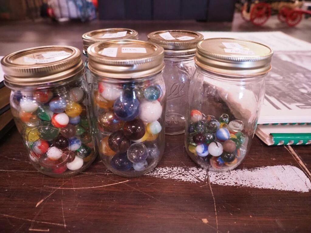 Two full pint jars of marbles and a half-full