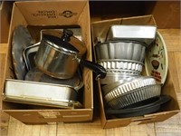 Two boxes of bakeware: cake pans, Bundt pans,