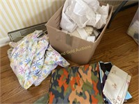 Box of blankets, sheets, throws