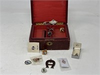 Wooden jewelry box with assorted pins, cuff links