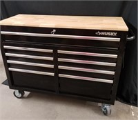 Large husky tool box with wood top on Wheels has