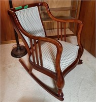 Stylish wooden rocking chair with a woven seat