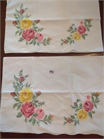 2 cross-stitched pillowcases