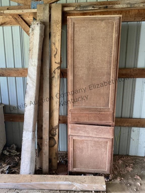 Tall cabinet and several pieces of wood