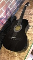 Black acoustic guitar in carrying bag