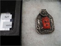 Unmarked pendant with red Buddha face