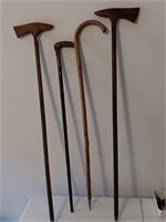 4 vintage walking canes, one has damage.
