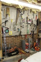 Wall deal of tools; saws, cords, straps, lug