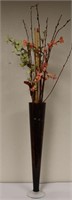 Ikebana floral arrangement in tall glass vase