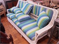 Wicker sofa with three cushions, upholstered