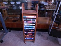 12 VHS movies in oak storage rack