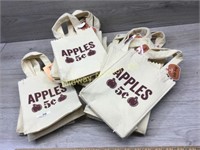 STACK OF APPLE TOTE BAGS