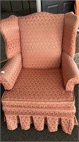 Wing back chair upholstered in pink, pleated