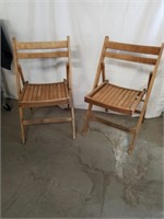 Two wood folding chairs missing one piece of wood