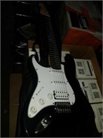 Black electric guitar and case