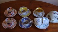 Nine various coffee cups with saucers