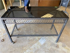 Metal framed table on casters with glass top-36x