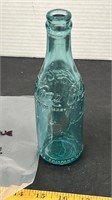 Flat Sided Blue Coca-Cola Bottle with Emblem on