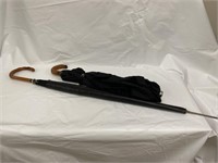 Lot of two black umbrellas one with leather case