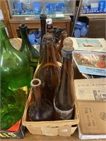assorted brown bottles in basket