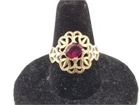 14kt Gold ornate ring with a slightly pink hued ga