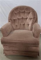 Cloth covered chair. Rocks and swivels.