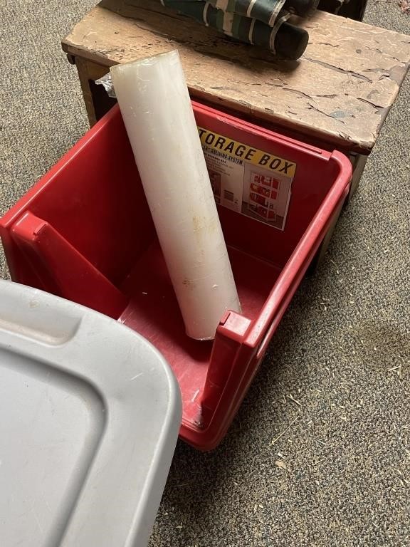 2 red storage containers, shrink wrap roll