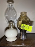 Pair of old oil lamps. Contents on top of book cas