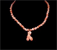 Carved angel skin coral pendant and beaded