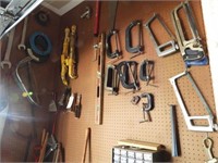 Qty of tools hanging on wall: C-Clamps, saws,