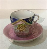 Decorative hand painted porcelain cup and saucer