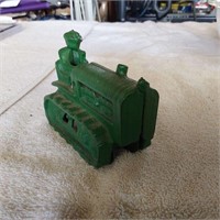 Green cast iron tractor on wheels