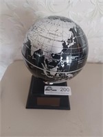 Small black and silver solar powered globe