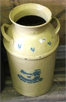 Old metal painted milk can with a chicken and a ba