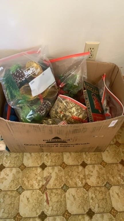 Box of Christmas decorations, tinsel, bulbs, and